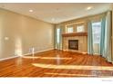 Spacious living room featuring hardwood floors and a gas fireplace at 13460 Trenton St, Thornton, CO 80602