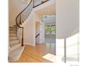 Elegant curved staircase with wrought-iron balusters at 13699 Pecos Loop, Broomfield, CO 80023