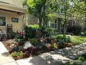 Landscaped front yard with colorful flowers, rocks, and a tree at 1494 Yaupon Ave, Boulder, CO 80304