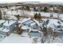 Bird's eye view of a house nestled in a snow covered neighborhood at 1524 E Weldona Way, Superior, CO 80027