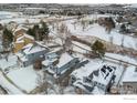 Snow covered homes and landscape with a view of a lake at 1524 E Weldona Way, Superior, CO 80027