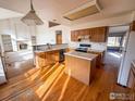 Eat-in kitchen with island and hardwood floors at 1524 E Weldona Way, Superior, CO 80027