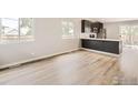 Open concept kitchen with dark cabinetry and quartz countertops at 1801 Donovan Dr, Longmont, CO 80501