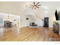 Open concept living and dining area with hardwood floors and a view into the kitchen at 1836 Juniper St, Longmont, CO 80501