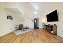 Bright living area with hardwood floors, vaulted ceiling, and a cozy sitting area at 1836 Juniper St, Longmont, CO 80501