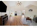 Spacious living room featuring a fireplace, vaulted ceiling and hardwood floors at 1836 Juniper St, Longmont, CO 80501