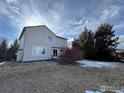 Back of house with deck, fenced yard, and winter landscaping at 1937 Reliance Cir, Superior, CO 80027