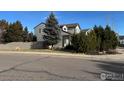 House exterior with landscaping, gray siding, and fenced backyard at 1937 Reliance Cir, Superior, CO 80027