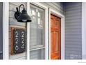 Gray house exterior with a wood door and modern house numbers at 2201 Pearl St # 224, Boulder, CO 80302