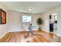 Elegant dining room with hardwood floors and view of kitchen at 2471 Harlan St, Edgewater, CO 80214