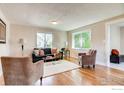 Spacious living room featuring hardwood floors and ample natural light at 2471 Harlan St, Edgewater, CO 80214