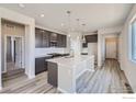 Modern kitchen featuring dark gray cabinets, white countertops, and an island at 2957 South Flat Cir, Longmont, CO 80503