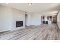 Spacious living room with wood-look floors and a modern fireplace at 2957 South Flat Cir, Longmont, CO 80503