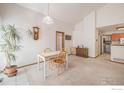 Small dining area with a simple table and chairs, adjacent to kitchen at 302 Victoria St, Berthoud, CO 80513