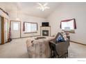 Bright living room with a fireplace and comfortable seating at 302 Victoria St, Berthoud, CO 80513