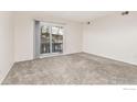 Bright bedroom with carpeted floor and sliding door to balcony at 3250 Oneal Cir # 17, Boulder, CO 80301