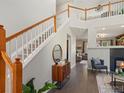 Bright entryway with staircase, hardwood floors, and modern decor at 3557 Blanca Peak Dr, Superior, CO 80027