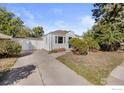 House with a driveway and attached two-car garage at 4455 S Logan St, Englewood, CO 80113