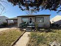 House exterior featuring a front porch and yard at 7901 Newport St, Commerce City, CO 80022