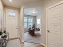 Bright entryway with view into home office and hardwood floors at 793 Griffith St, Lochbuie, CO 80603