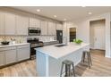 Modern kitchen featuring island, stainless steel appliances, and light cabinets at 793 Griffith St, Lochbuie, CO 80603