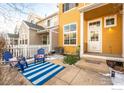 Relaxing patio area with blue striped rug and comfortable seating at 911 Snowberry St, Longmont, CO 80503