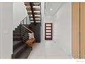 Bright and airy entryway with modern staircase and built-in bench at 104 Old Sunshine Trl, Boulder, CO 80302