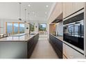 Modern kitchen with high-end appliances and wood cabinetry at 104 Old Sunshine Trl, Boulder, CO 80302