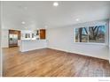 Hardwood floor living room, open to kitchen with island at 10690 W 47Th Pl, Wheat Ridge, CO 80033