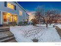 Two-story townhome with light gray siding and a snowy front yard at 1419 Red Mountain Dr # 13, Longmont, CO 80504