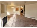 Spacious living room with fireplace and view into kitchen at 1419 Red Mountain Dr # 71, Longmont, CO 80504