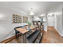 Bright dining area with wood table, bench seating, and modern decor at 1818 S Quebec Way # 13-2, Denver, CO 80231