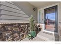 Inviting front entry with stonework and a welcoming door at 2163 Chianina St, Mead, CO 80542