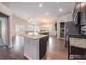 Modern kitchen with granite counters and stainless steel appliances at 2163 Chianina St, Mead, CO 80542