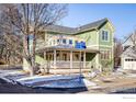 Green house with a wrap-around porch and street view at 2613 Thornbird Pl, Boulder, CO 80304