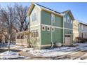 Side view of a green house with a detached garage at 2613 Thornbird Pl, Boulder, CO 80304