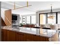 Modern kitchen with marble countertops and a large island, open to dining area at 2940 14Th St, Boulder, CO 80304