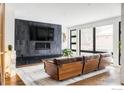 Living room featuring a rustic wooden sofa and a large TV above a fireplace at 2940 14Th St, Boulder, CO 80304