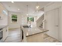 Modern kitchen with granite countertops and island at 357 Fickel Farm Trl, Berthoud, CO 80513