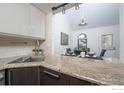 Kitchen boasts granite countertops and a pass-through to the dining area at 380 S Taft Ct, Louisville, CO 80027