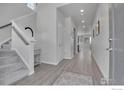 Bright entryway with stairs, light flooring, and a small table at 390 Blackfoot St, Superior, CO 80027