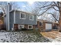 Two-story home with gray siding and brick accents, showcasing a well-maintained lawn at 399 Jackson Cir, Louisville, CO 80027