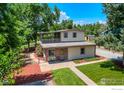 Two-story house with a detached garage and a small yard at 4525 S Delaware St, Englewood, CO 80110