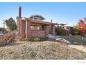 Brick home with a charming front porch and landscaped yard at 601 Jackson St, Denver, CO 80206