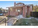 Brick home with a charming front porch and landscaped yard at 601 Jackson St, Denver, CO 80206