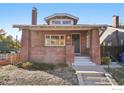 Brick home with a charming front porch and landscaped yard at 601 Jackson St, Denver, CO 80206