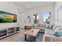 Spacious living room with sectional sofa and large TV at 616 Discovery Pkwy, Superior, CO 80027