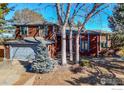 Two-story home with wood siding, attached garage, and landscaping at 649 W Birch Ct, Louisville, CO 80027