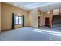 Bright living room with hardwood floors and a staircase at 649 W Birch Ct, Louisville, CO 80027