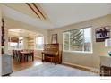 Open dining room with wooden table, chairs, and a piano at 6646 Bean Mountain Ln, Boulder, CO 80301